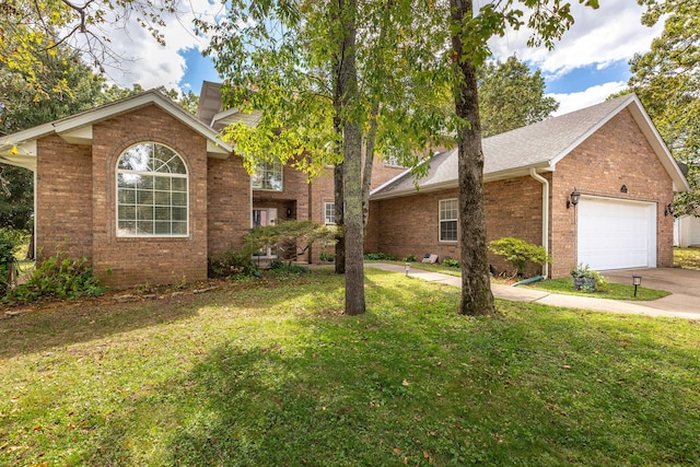 view of front of property with a front yard and a garage