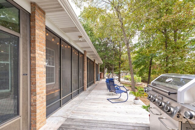 wooden terrace with a grill