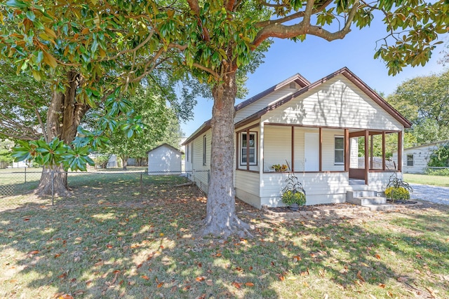 view of front of property with covered porch and a front yard