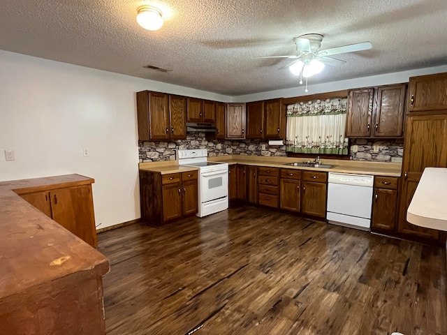 kitchen with white appliances, tasteful backsplash, sink, a textured ceiling, and dark hardwood / wood-style floors