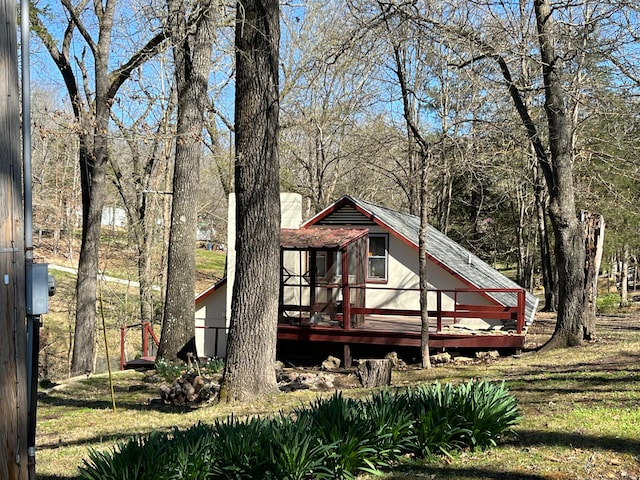 rear view of house featuring a deck