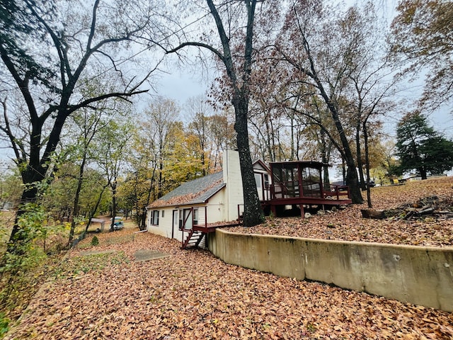 view of side of property featuring a wooden deck