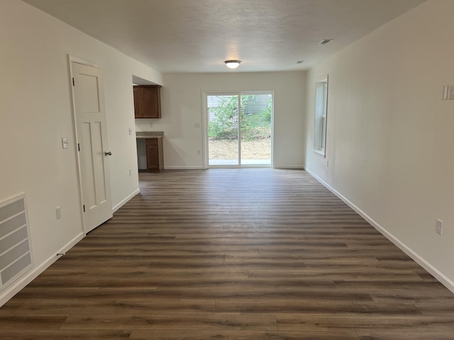 4073 White Oak Lot 4, Merriam Woods, MO 65740 - unfurnished living room featuring dark wood-type flooring and baseboards