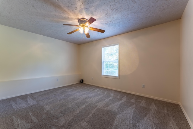 carpeted empty room featuring ceiling fan and a textured ceiling