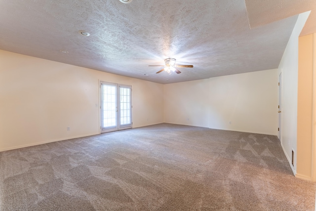 unfurnished room with a textured ceiling, carpet floors, and ceiling fan