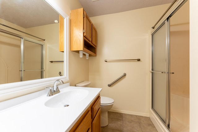 bathroom featuring tile patterned floors, toilet, a textured ceiling, and walk in shower