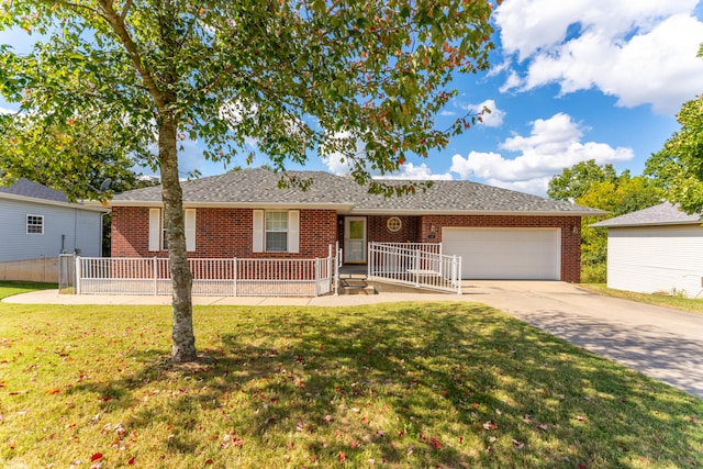 single story home featuring a garage and a front lawn