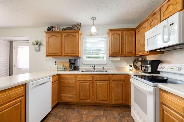 kitchen featuring a textured ceiling, white appliances, sink, and hanging light fixtures