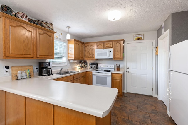 kitchen with kitchen peninsula, pendant lighting, white appliances, and sink