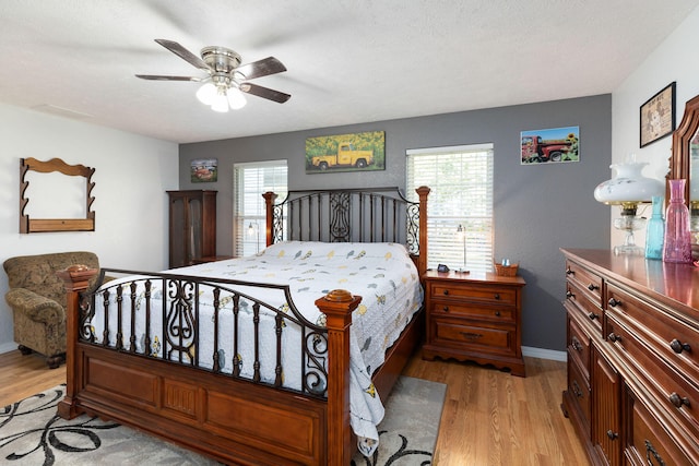 bedroom with ceiling fan and light hardwood / wood-style flooring