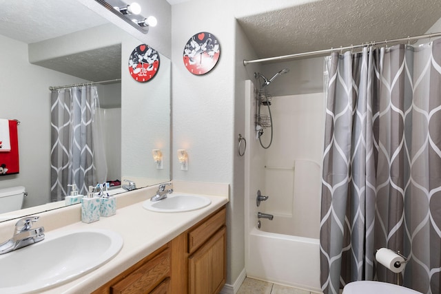 full bathroom featuring tile patterned flooring, a textured ceiling, toilet, shower / tub combo with curtain, and vanity