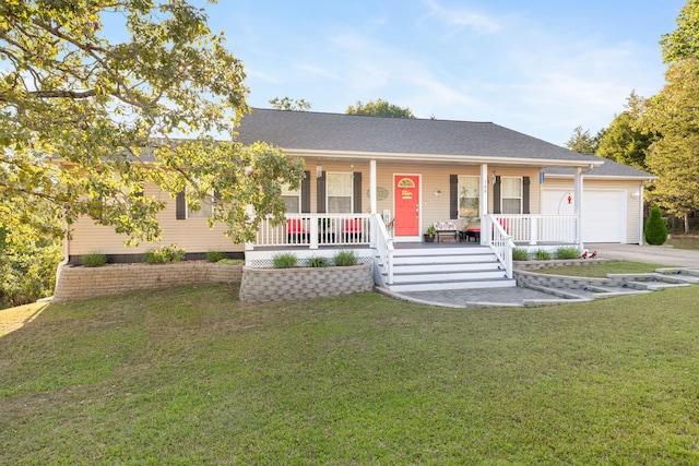 single story home with covered porch, a garage, and a front lawn