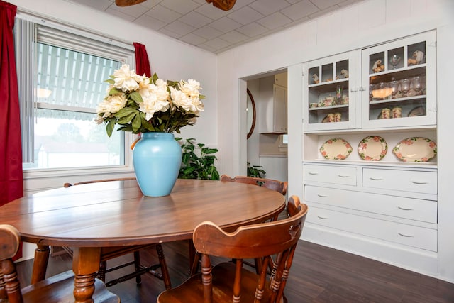 dining space with dark hardwood / wood-style flooring