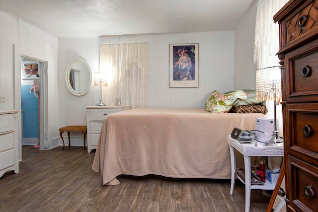 bedroom with dark wood-type flooring