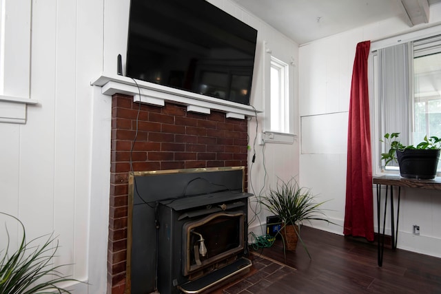 interior details with hardwood / wood-style floors and a wood stove