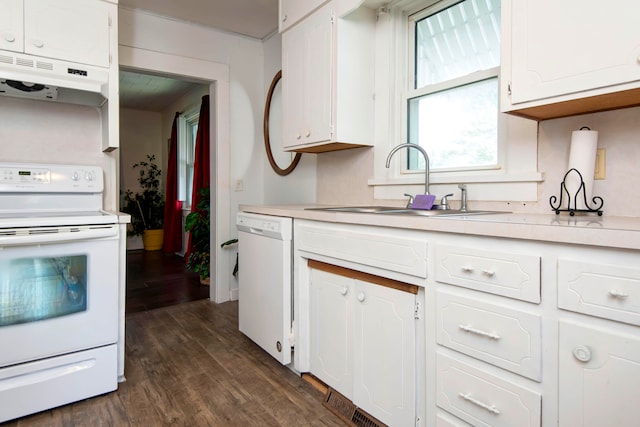 kitchen with white cabinets, sink, dark wood-type flooring, and white appliances