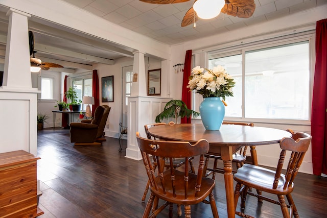 dining area with ornate columns, ceiling fan, and dark wood-type flooring