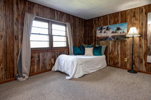 bedroom with wooden walls and carpet