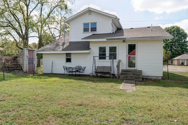 rear view of property with a yard