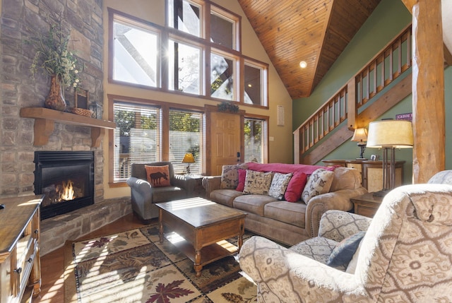 living room featuring high vaulted ceiling, a fireplace, hardwood / wood-style floors, and wood ceiling