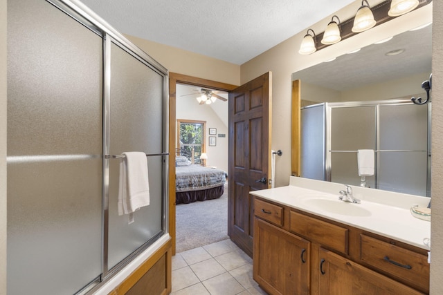 bathroom featuring ceiling fan, an enclosed shower, tile patterned floors, vanity, and a textured ceiling