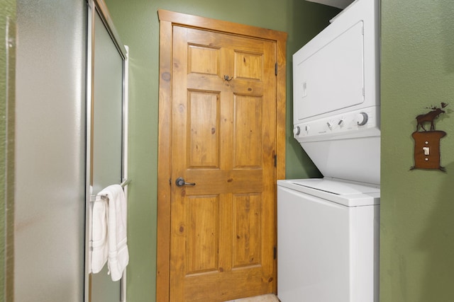 clothes washing area with stacked washer / drying machine