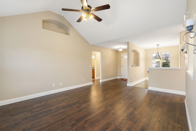 empty room with vaulted ceiling, dark hardwood / wood-style flooring, and ceiling fan