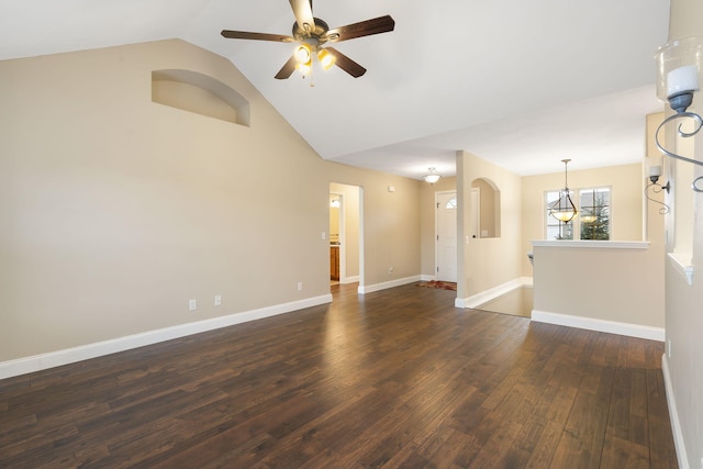 unfurnished room with lofted ceiling, a ceiling fan, baseboards, and dark wood-type flooring
