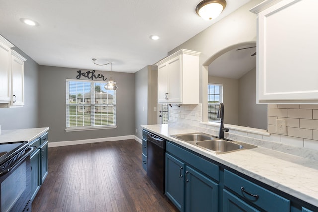 kitchen with blue cabinets, a sink, dark wood-style flooring, black appliances, and white cabinetry