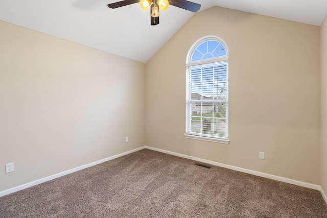 carpeted spare room with lofted ceiling, a ceiling fan, visible vents, and a wealth of natural light