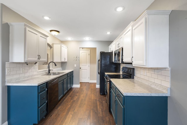 kitchen with black dishwasher, electric range oven, blue cabinetry, and a sink