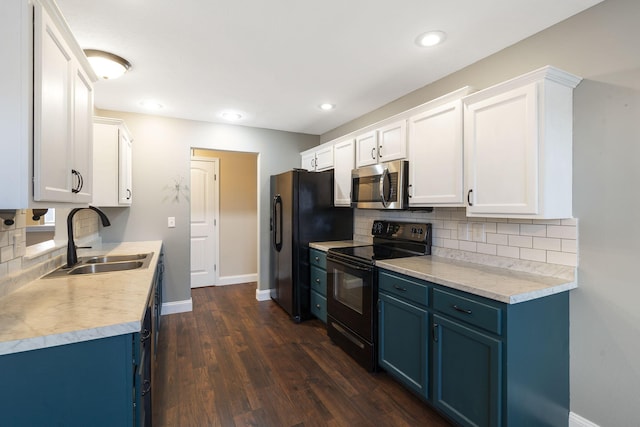 kitchen with blue cabinets, a sink, tasteful backsplash, baseboards, and black appliances