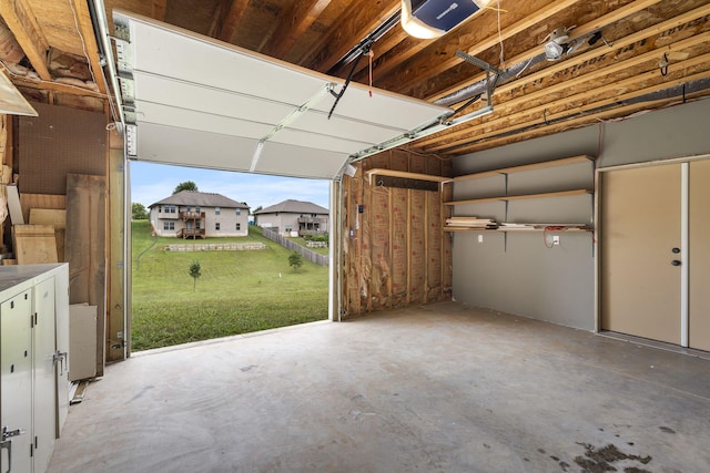 garage featuring a garage door opener and a lawn