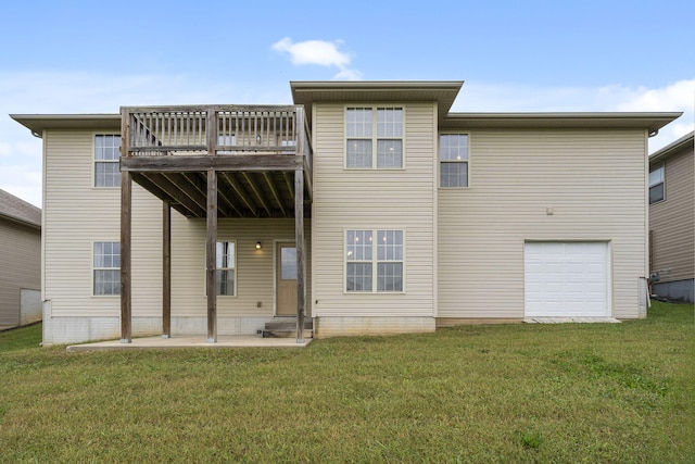 rear view of property with a garage, a patio area, a lawn, and a deck