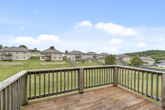 deck featuring a yard, a residential view, and a fenced backyard