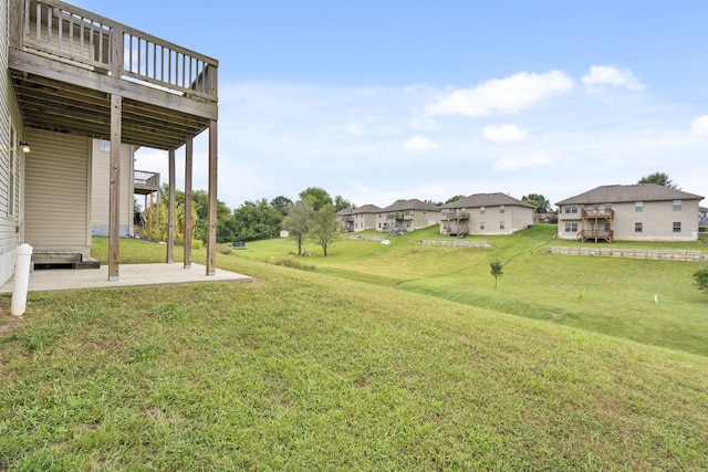 view of yard featuring a wooden deck and a patio area