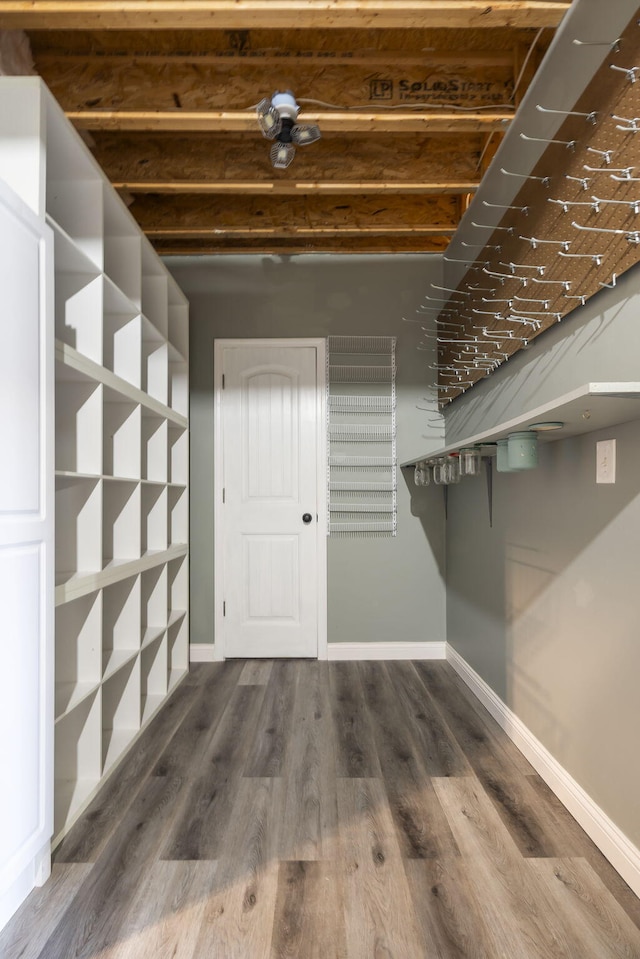 interior space featuring wood finished floors and baseboards