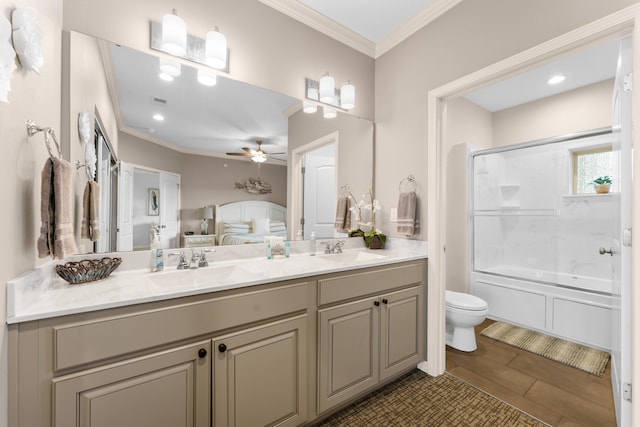 full bathroom with ceiling fan, vanity, ornamental molding, combined bath / shower with glass door, and toilet