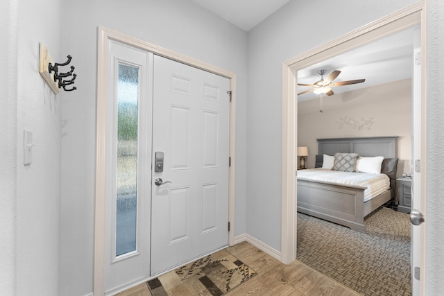 entryway with ceiling fan and light wood-type flooring