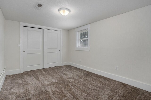 unfurnished bedroom featuring carpet and a closet