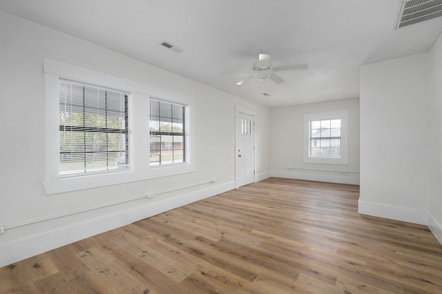 unfurnished room featuring hardwood / wood-style flooring and ceiling fan