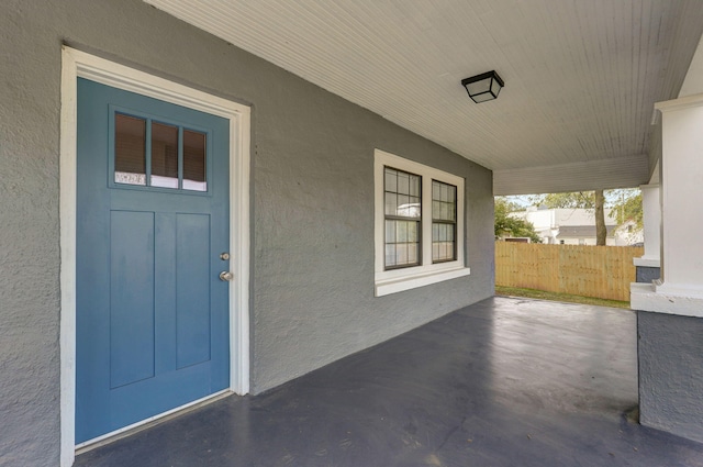 view of exterior entry with covered porch