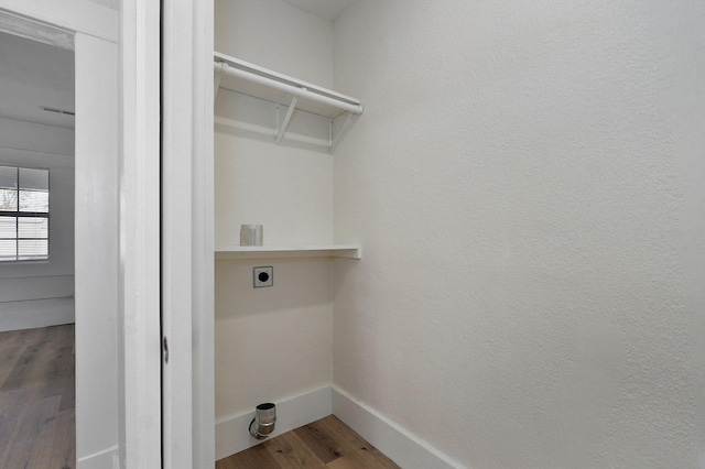 laundry room with hardwood / wood-style flooring and hookup for an electric dryer