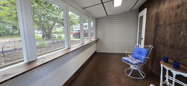 unfurnished sunroom featuring lofted ceiling