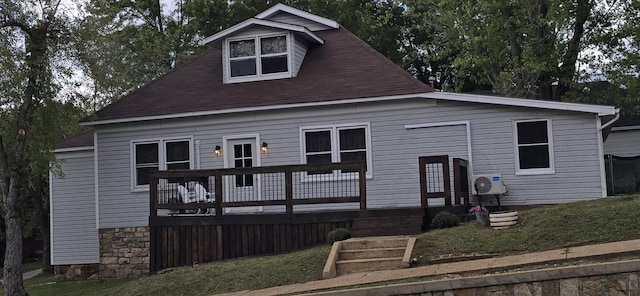 view of front facade with a deck and a front yard