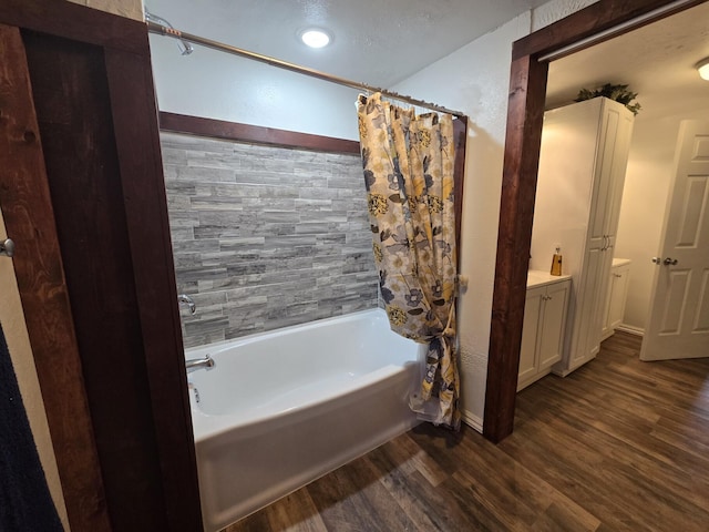 bathroom featuring vanity, wood-type flooring, and shower / bath combo with shower curtain