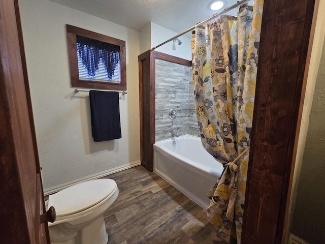 bathroom with hardwood / wood-style floors, shower / bath combination with curtain, and toilet