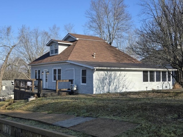 view of property exterior featuring a yard and a deck