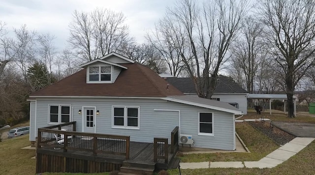 rear view of property featuring a carport, ac unit, a deck, and a lawn