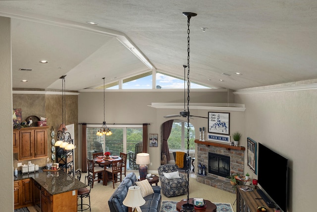 carpeted living room with a brick fireplace, ornamental molding, lofted ceiling with beams, and a chandelier